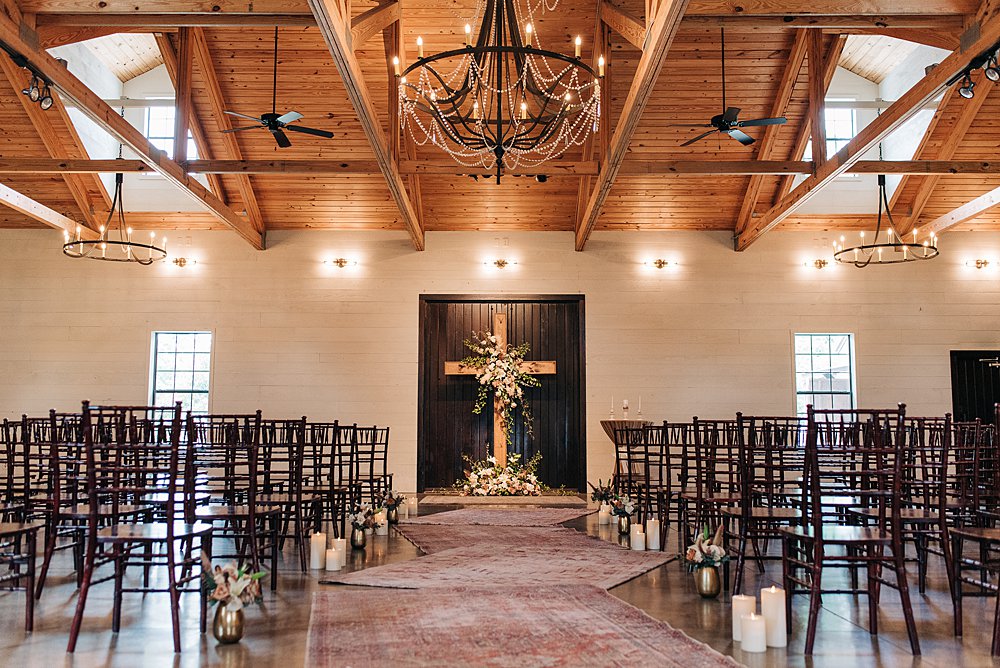rustic indoor ceremony space with industrial chandelier at The Barn at Shady Lane in Alabama